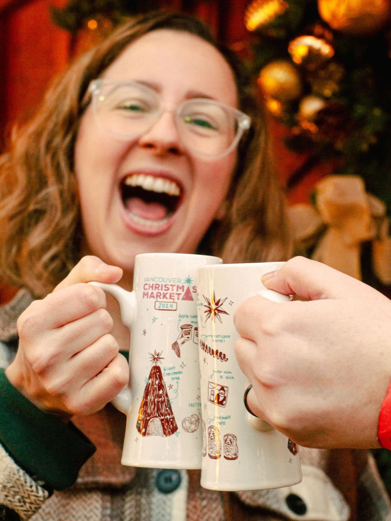 Friends cheersing drinks at the Vancouver Christmas Market