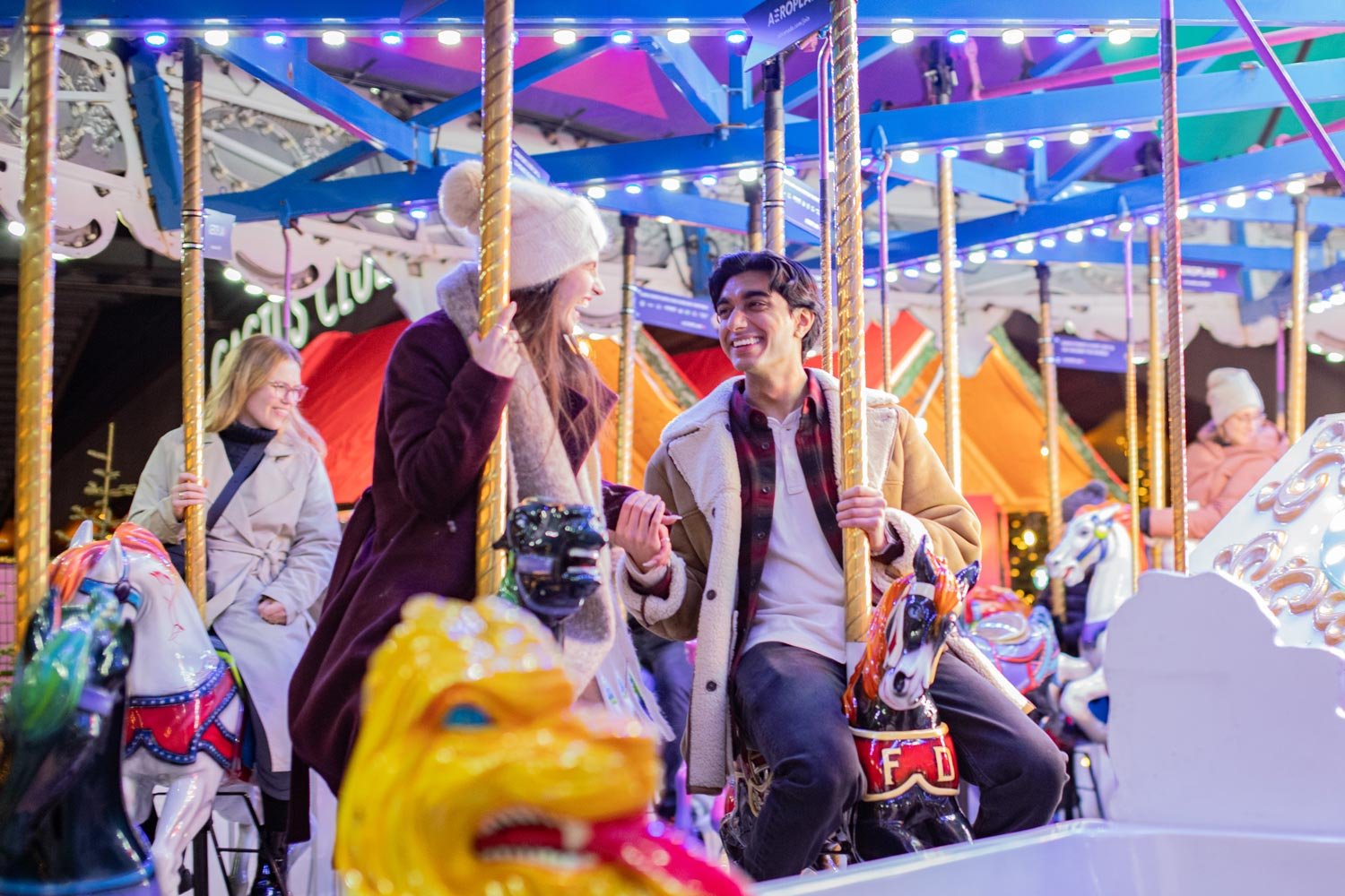 A couple riding the Carousel at the Vancouver Christmas Market